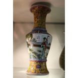 A Chinese Famille Jaune baluster shaped vase, the body decorated with female figures.