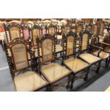 An impressive set of twelve early 20th century Indian teak dining chairs, two with arms all with