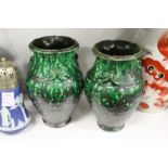 A pair of green glazed pottery vases.