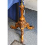 A good carved walnut and brass tripod lamp standard.