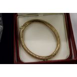 An Annabel Jones 9ct gold bangle, with original box.