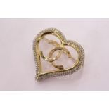 A decorative heart shaped brooch.