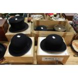 Two bowler hats and three top hats, some with boxes.