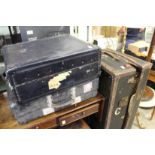 A wardrobe trunk and two other cases.