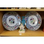 A pair of decorative plates, a porcelain figure and a frosted glass scent bottle.