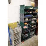 A folding ladder Workmate and a quantity of storage shelves containing numerous tools.