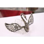 A silver mounted cut glass table salt in the form of a swan with hinged wings.