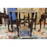 A large eastern engraved and painted circular copper tray table on folding stand.