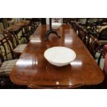 A good George III design mahogany twin pedestal dining table with two extra leaves.