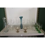A modern glass decanter, a stylish glass vase and other glassware.
