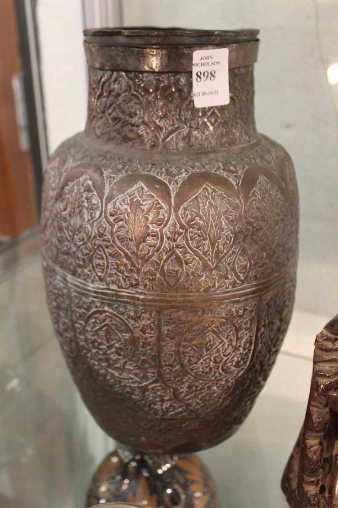 A large eastern embossed metal vase.