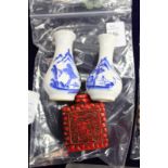 A small pair of Chinese blue and white vases and a cinnabar snuff bottle.