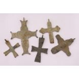 A group of bronze crosses.