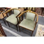 A pair of mahogany shaped horseshoe shaped armchairs.