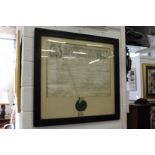 A large framed and glazed indenture with wax seal.