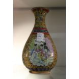 A Chinese Famille Jaune bottle shaped vase decorated with female figures.