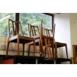 A set of four stylish teak dining chairs.