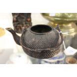 A Chinese cast iron teapot.