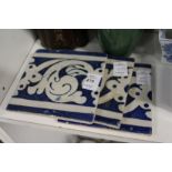 Three Islamic blue and white tiles.