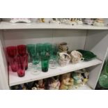 A collection of cranberry and green glassware, Derby cups and saucers and a cabbage leaf dish.