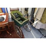 An unusual rare early leather and wrought iron pram.