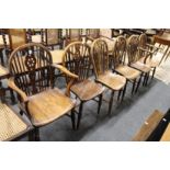 Six 19th century ash and elm wheel back dining chairs, two with arms.