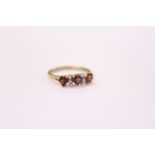 A 9ct gold ring set with three heart shaped stones.