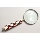 A MAGNIFYING GLASS with chequered handle