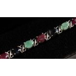 A SILVER RUBY, SAPPHIRE AND EMERALD LINE BRACELET