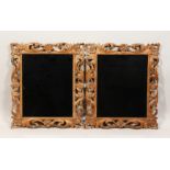 A PAIR OF 19TH CENTURY MIRRORS with leaf and flower carved wood frames 22ins x 19ins