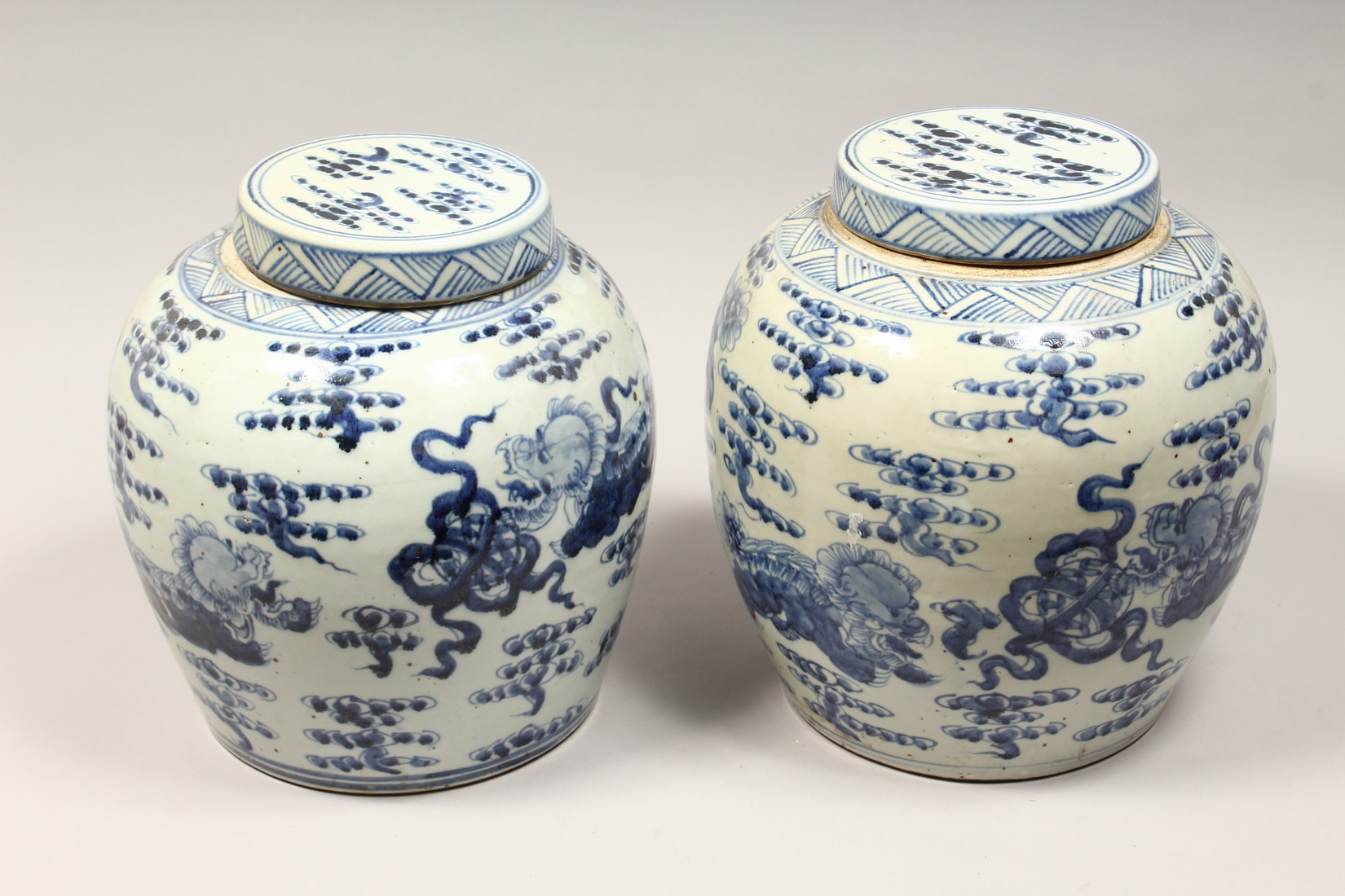 A PAIR OF CHINESE BLUE AND WHITE PORCELAIN JARS AND COVERS, painted with lion dogs 12.5ins high. - Image 2 of 8