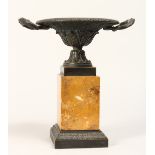 A REGENCY BRONZE TWO HANDLED CIRCULAR TAZZA on a marble plinth 9ins high