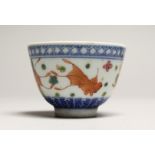 A CHINESE PORCELAIN TEA BOWL decorated with fish. Signed, mark in blue 3ins diameter.