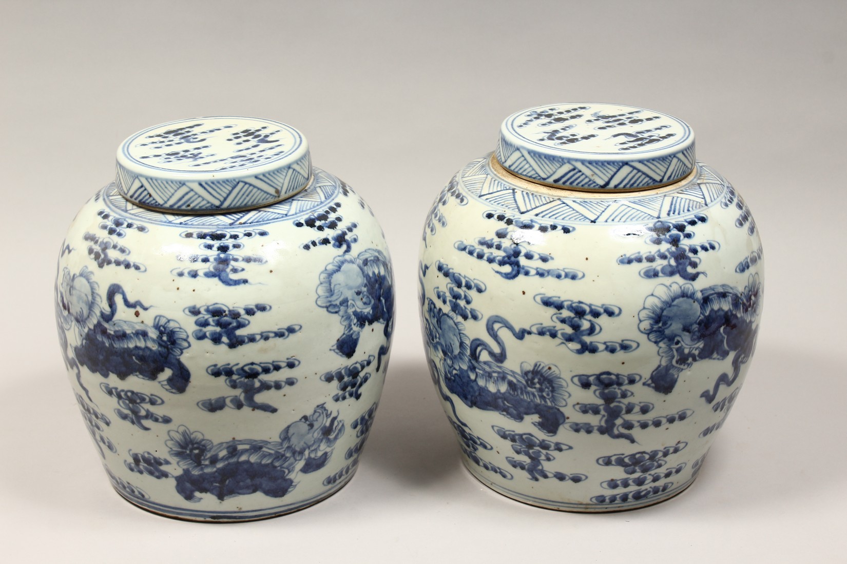 A PAIR OF CHINESE BLUE AND WHITE PORCELAIN JARS AND COVERS, painted with lion dogs 12.5ins high. - Image 3 of 8