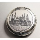 A RUSSIAN NIELLO CIRCULAR SNUFF BOX with a scene of Moscow. 2.5ins diameter.