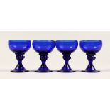 A SET OF FOUR BRISTOL BLUE GLASSES 3.5ins high.