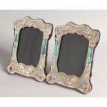 A PAIR OF SILVER AND ENAMEL ART NOUVEAU STYLE PHOTOGRAPH FRAMES 8.5ins x 5.5ins