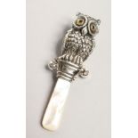 A BABY'S OWL AND MOTHER OF PEARL RATTLE
