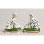 A SMALL PAIR OF PORCELAIN GROUPS OF DALMATIONS 3ins high
