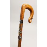 A SCOTTISH WALKING STICK with thistle handle and mounted with emblems 40ins long.