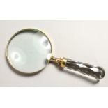 A MAGNIFYING GLASS with cut glass handle