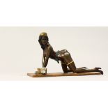 AN EROTIC BRONZE GROUP OF A SEMI NUDE WOMAN, cleaning a floor. 9ins long