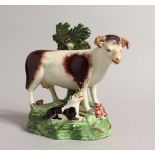 A PAIR OF STAFFORDSHIRE BOCAGE GROUPS OF A COW AND CALF 5.5ins high.
