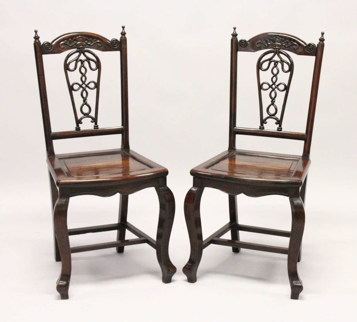 A GOOD PAIR OF 19TH CENTURY REDWOOD CHINESE CHAIRS with pierced backs and solid seats on curving