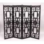 A CHINESE BLACK LACQUER FOUR SECTION CARVED WOOD FOLDING DRESSING SCREEN. Each panel 5ft 3ins high x