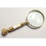 A MAGNIFYING GLASS with mother of pearl and gilt handle