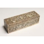 A CHINESE SILVER LONG BOX AND COVER repousse with dragons. 5ins long.