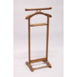 A HARDWOOD CLOTHES VALET 3f 5.5ins high.