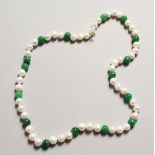 A STRING OF PEARL AND JADE BEADS with 14ct gold clasp.