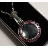 A SILVER RUBY HAND MAGNIFYING GLASS.